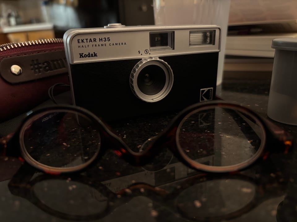 half frame film camera on a table with reading classes in the foreground